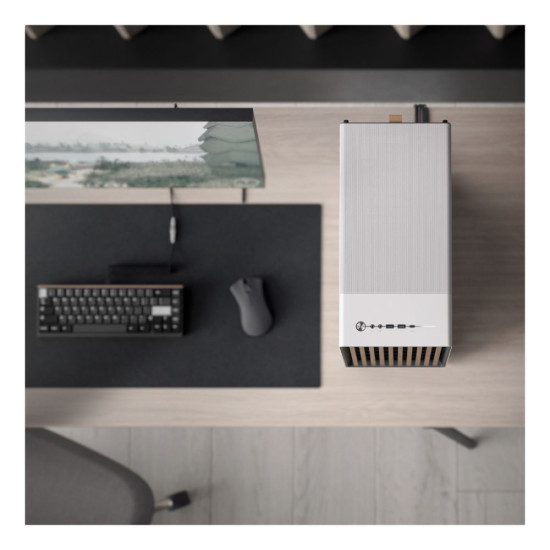 Fractal Design North Chalk  White Mesh Mid Tower PC Case placed next to a PC setup (Mouse, monitor and keyboard)